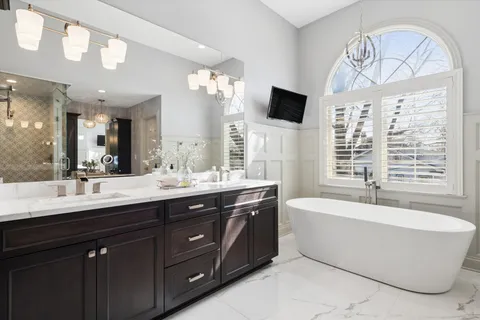 a bathroom with a shower sink and mirror
