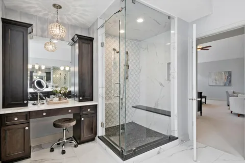 a living room with furniture a plant and a bookshelf