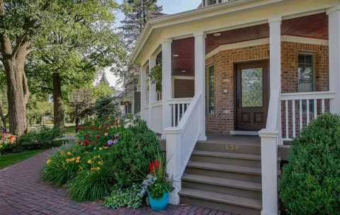 a front view of a house with plants and garden
