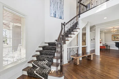 a view of entryway and hall with wooden floor