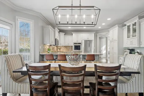 a kitchen with granite countertop appliances cabinets and chairs