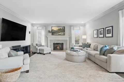 a living room with furniture and a dining table with kitchen view