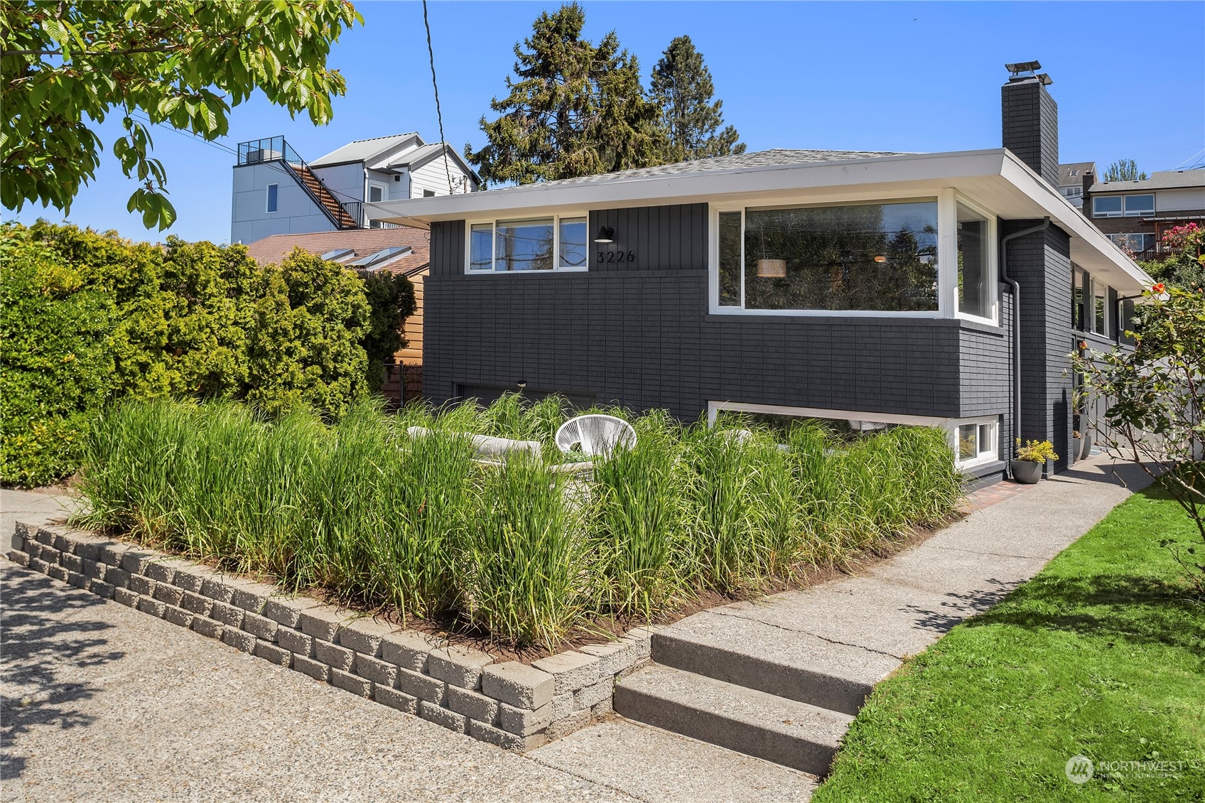 3226 60th Avenue Southwest Seattle, WA 98116 - Photo 1 of 34 a front view of a house with a yard