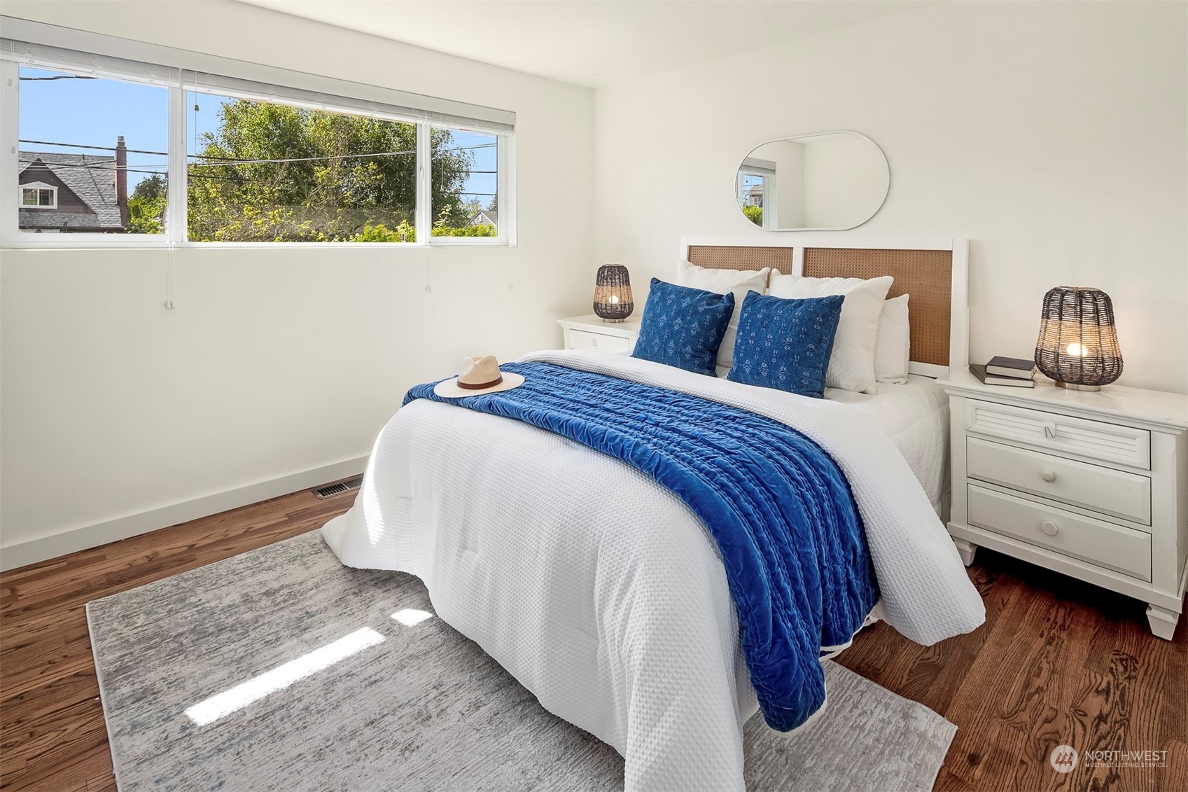 3226 60th Avenue Southwest Seattle, WA 98116 - Photo 13 of 34 a bedroom with a bed and a window