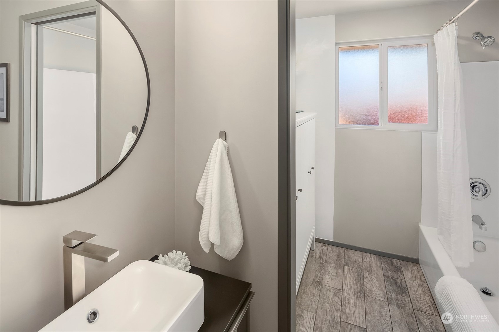 3226 60th Avenue Southwest Seattle, WA 98116 - Photo 22 of 34 a bathroom with a sink and a mirror