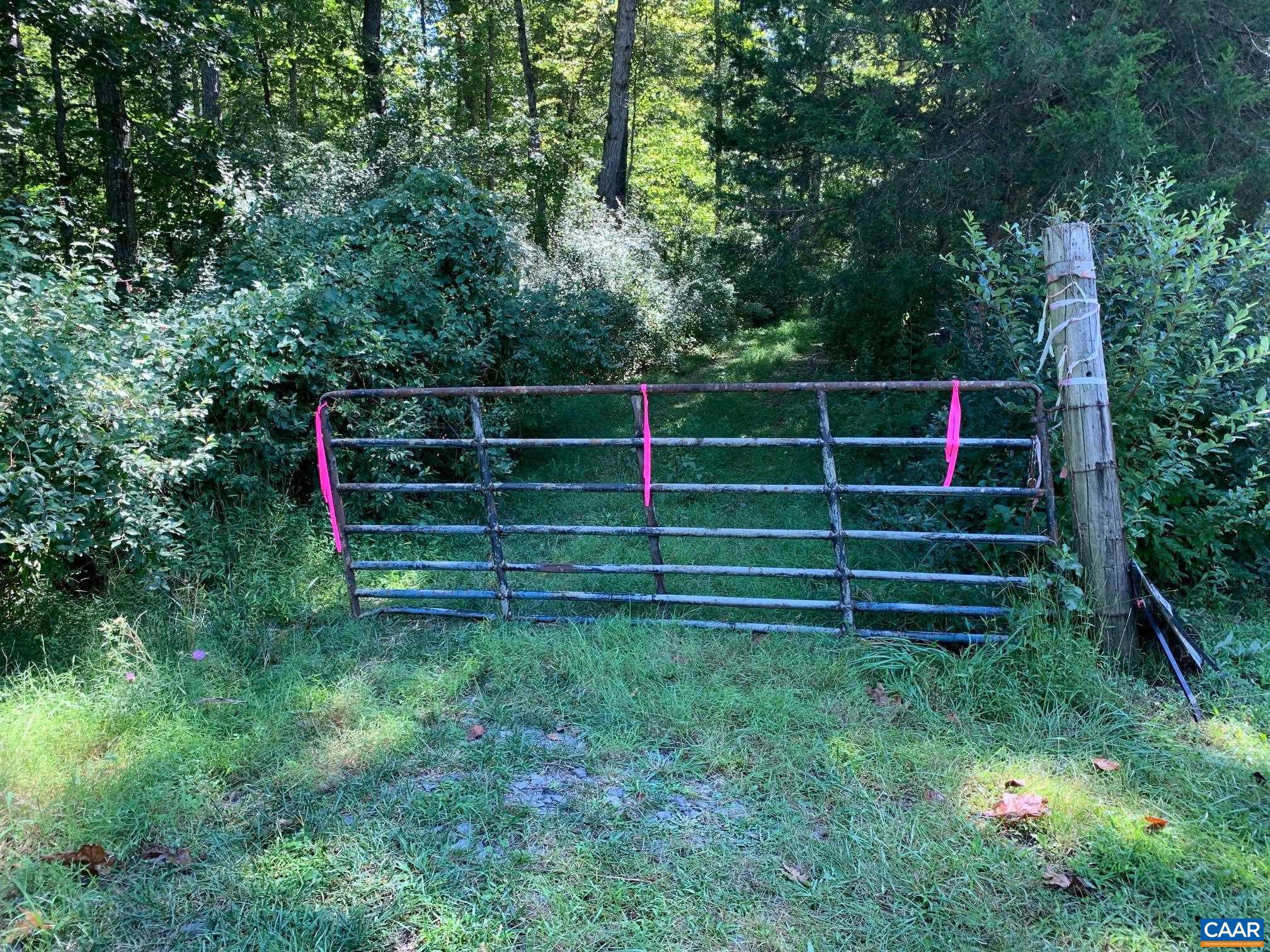 6-42 Holly Springs Road, Unit 42 Amissville, VA 20106 - Photo 1 of 18 a view of a backyard with plants and wooden fence