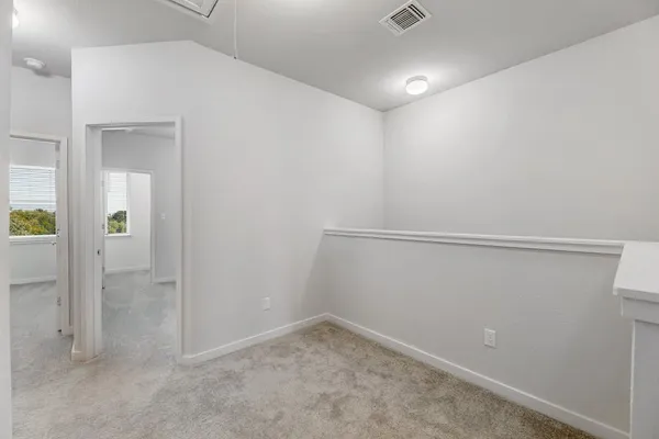 an empty room with windows and entrance