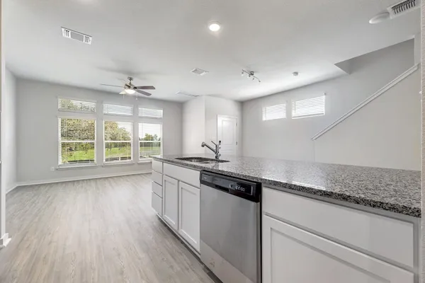 a kitchen with stainless steel appliances granite countertop a stove microwave and refrigerator