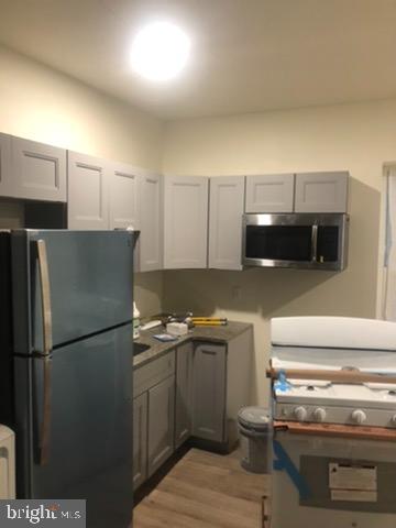 137 North Dearborn Street Philadelphia, PA 19139 - Photo 2 of 4 a kitchen with a refrigerator and a sink