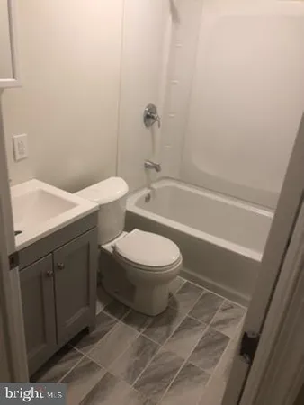 a bathroom with a toilet a sink and bathtub