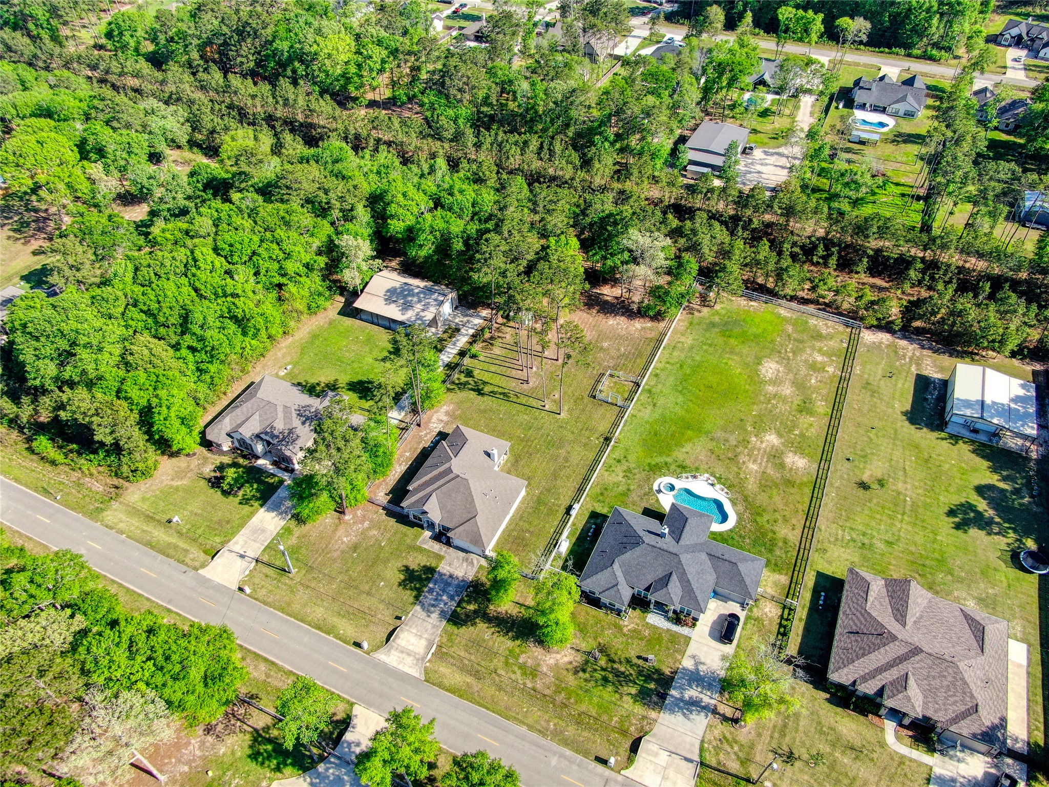 27684 Rio Blanco Drive Splendora, TX 77372 - Photo 27 of 31 an aerial view of a house with a yard lake and outdoor seating