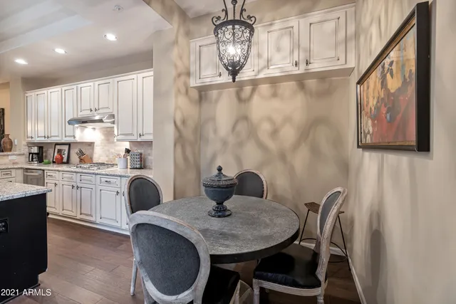 a kitchen with a table chairs sink and cabinets