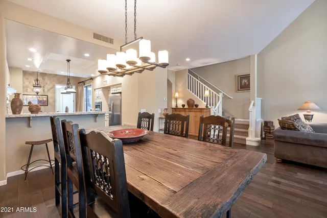a view of a dining room with furniture a chandelier and wooden floor