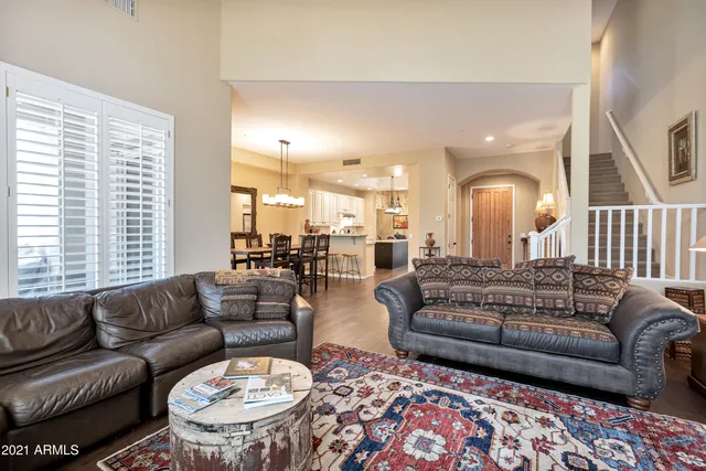 a bedroom with a bed window and a flat tv screen