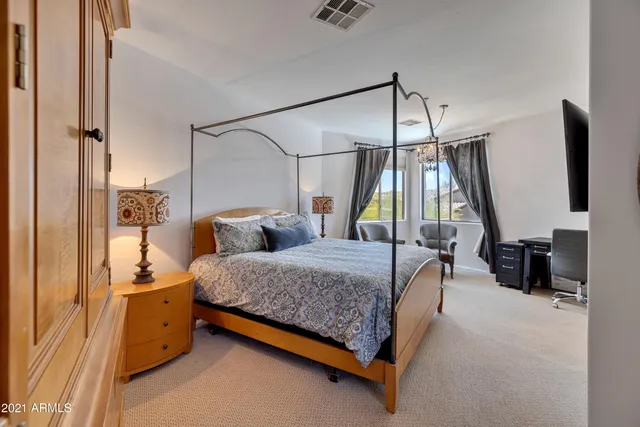 a bedroom with furniture and a flat screen tv