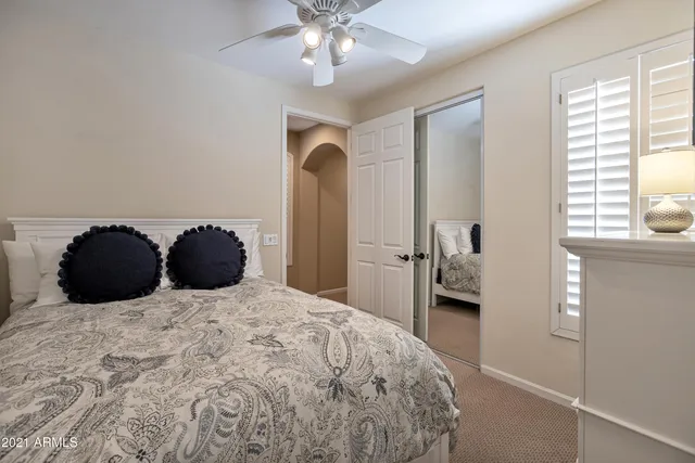 a bedroom with a bed and a chandelier