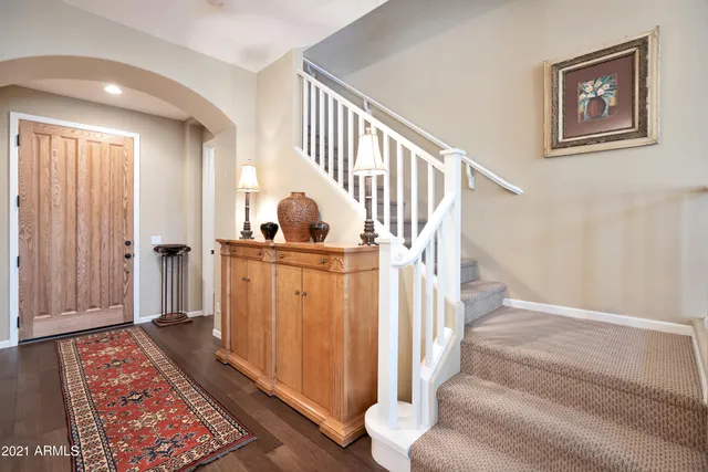 a view of entryway and hall with wooden floor
