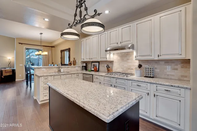 a kitchen with stainless steel appliances granite countertop a stove and cabinets