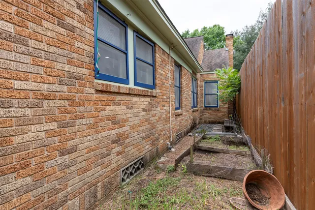 a view of a backyard with a tub and wooden fence