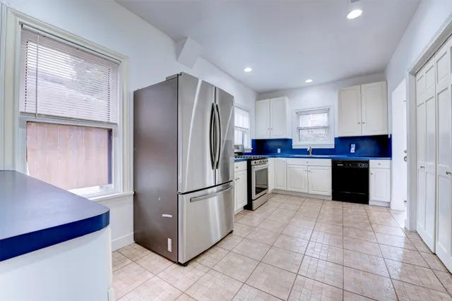 a kitchen with stainless steel appliances granite countertop a refrigerator sink and cabinets
