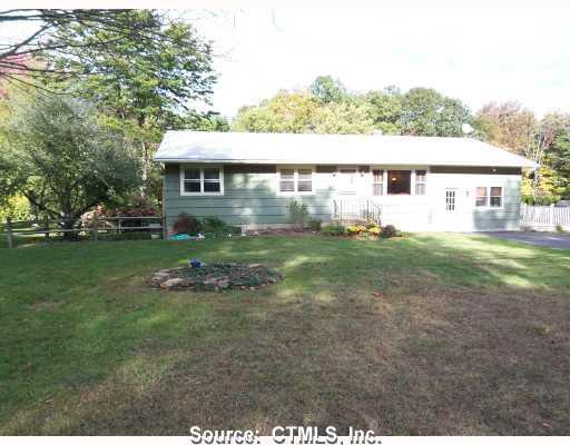 396 Regan Road Middlebury, CT 06762 - Photo 1 of 1 a backyard of a house with table and chairs