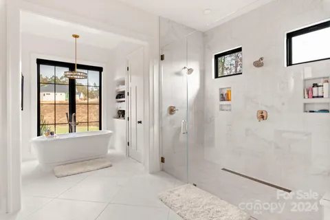 a bathroom with a tub shower and sink