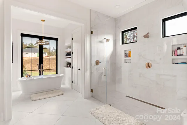 a bathroom with a tub shower and sink