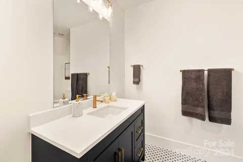 a bathroom with a sink a vanity and a mirror