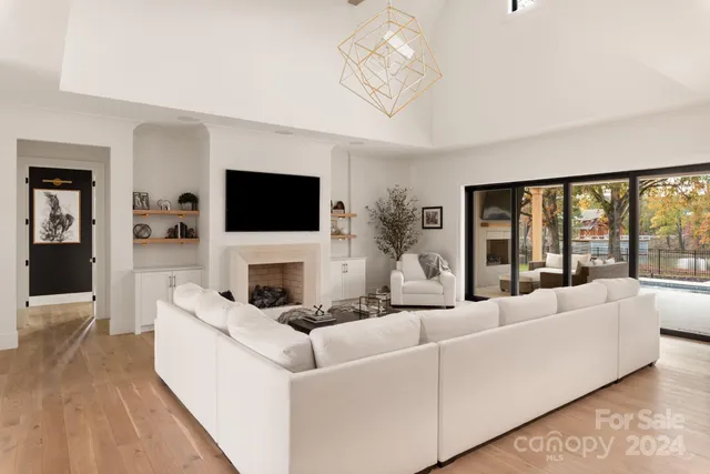 a living room with fireplace furniture and a flat screen tv