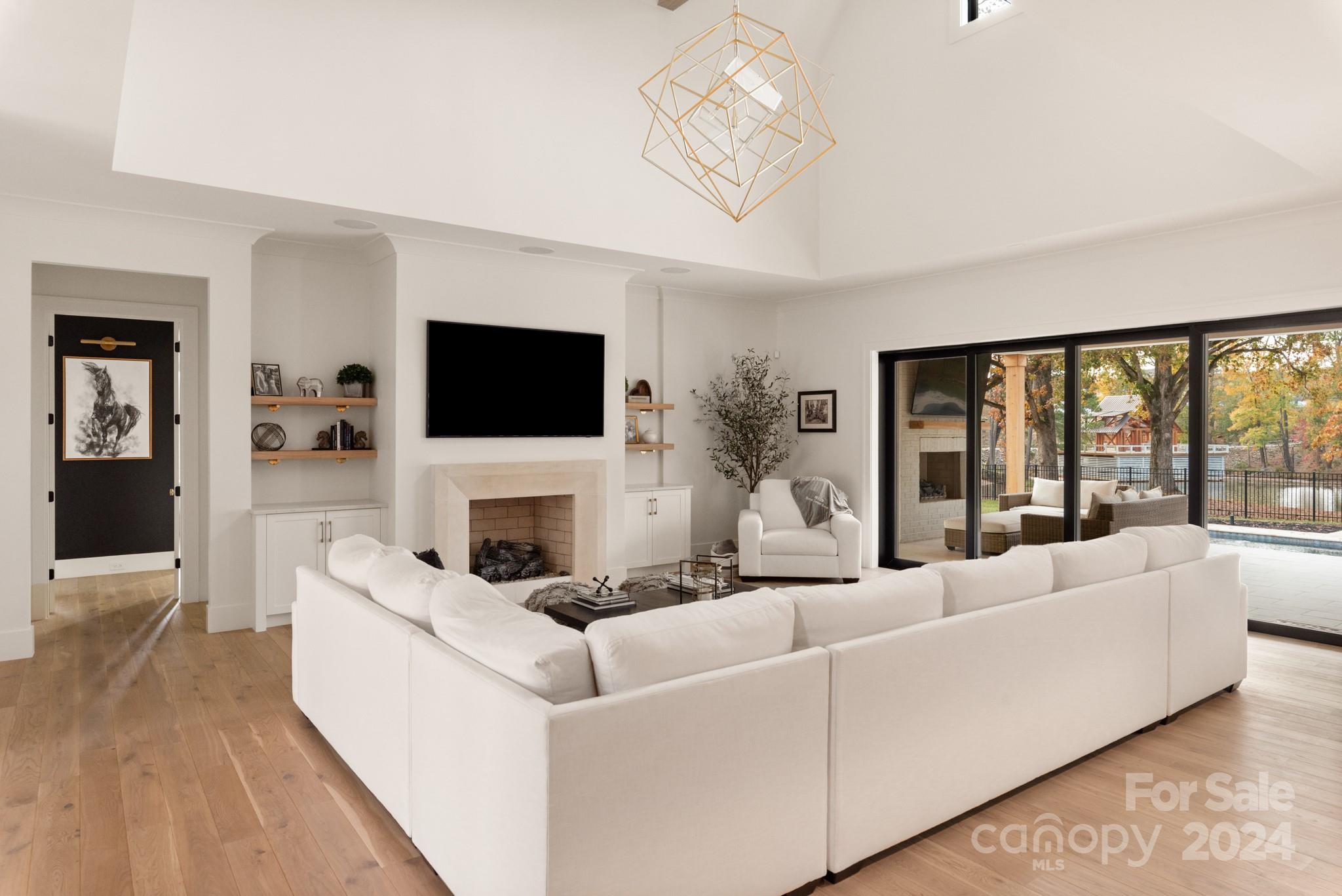 1017 Maxwell Court, Unit 5 Marvin, NC 28173 - Photo 2 of 26 a living room with fireplace furniture and a flat screen tv