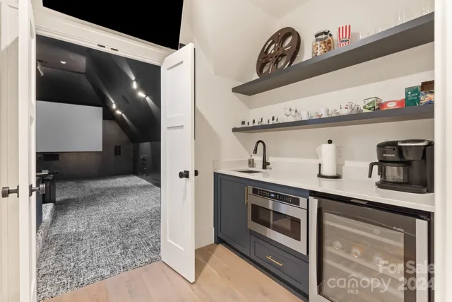 a kitchen with stainless steel appliances granite countertop a sink and a stove