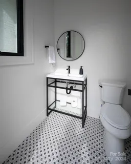 a bathroom with a toilet a sink and a mirror