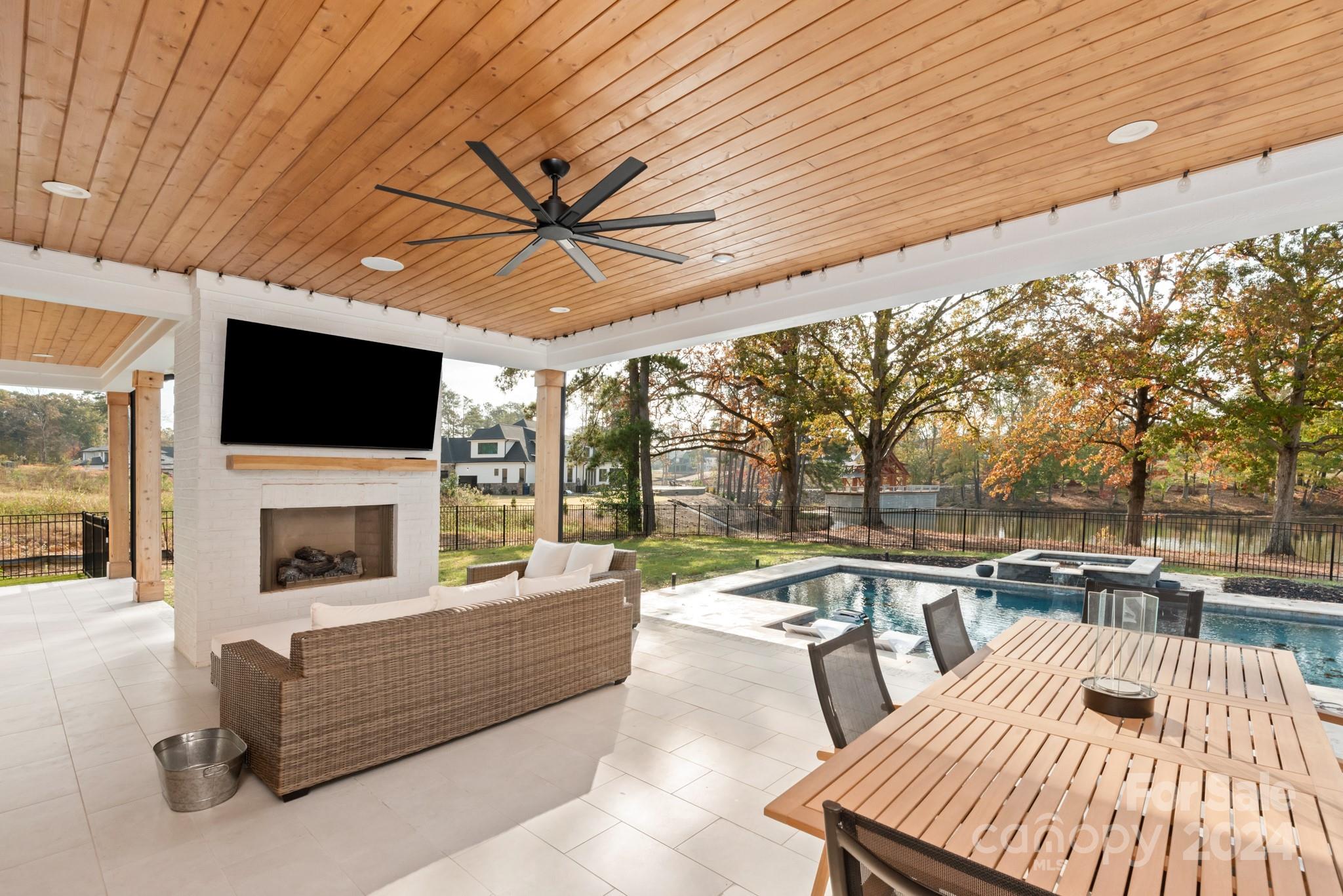1017 Maxwell Court, Unit 5 Marvin, NC 28173 - Photo 4 of 26 a living room with patio furniture and a flat screen tv