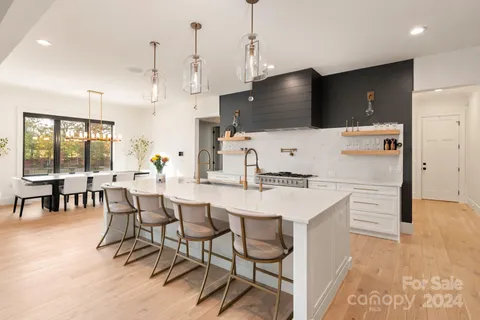 a kitchen with a sink a counter top space and stainless steel appliances