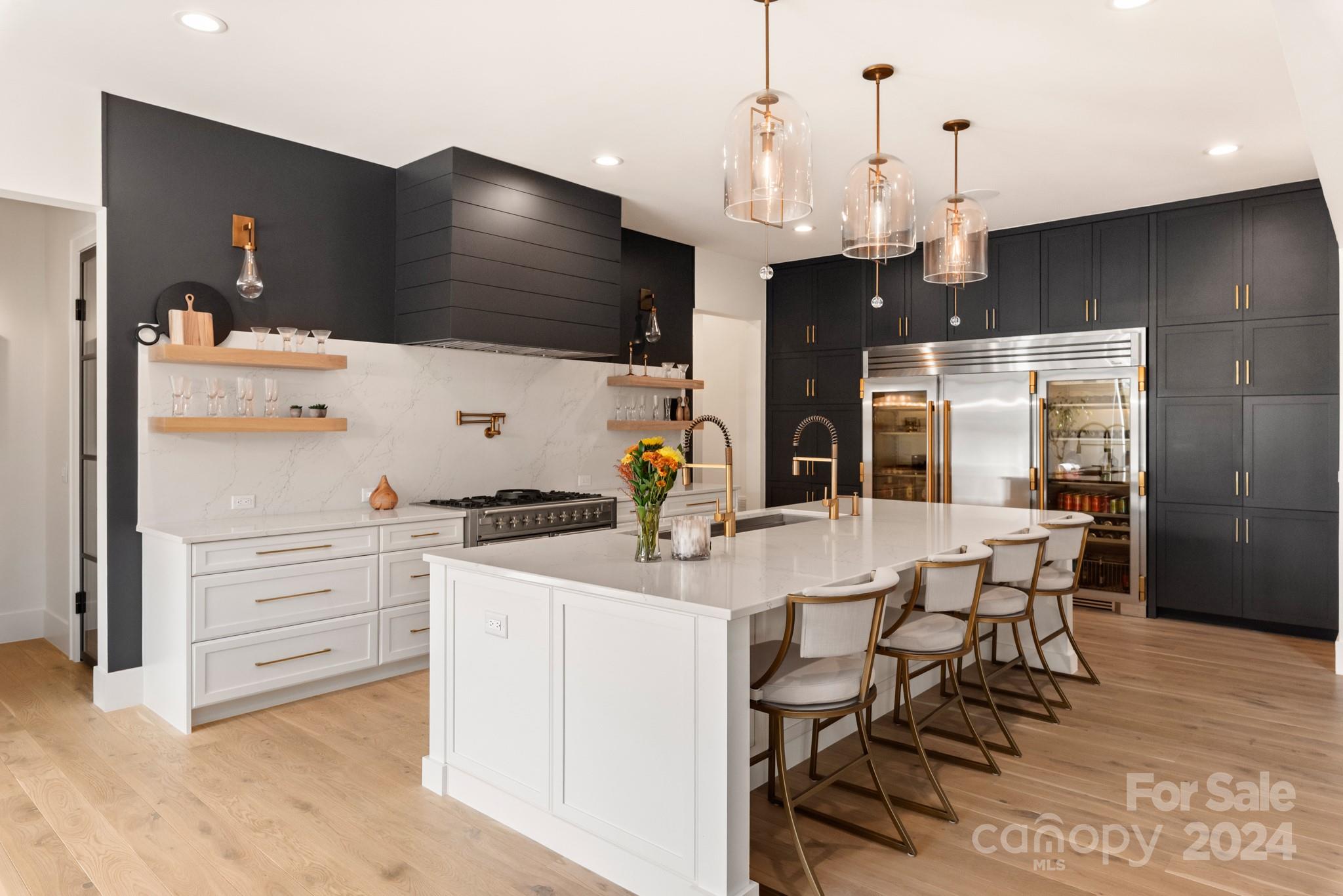 1017 Maxwell Court, Unit 5 Marvin, NC 28173 - Photo 7 of 26 a kitchen with stainless steel appliances kitchen island granite countertop a table chairs and a refrigerator