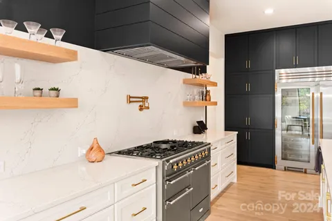 a kitchen with stainless steel appliances granite countertop a stove and a refrigerator