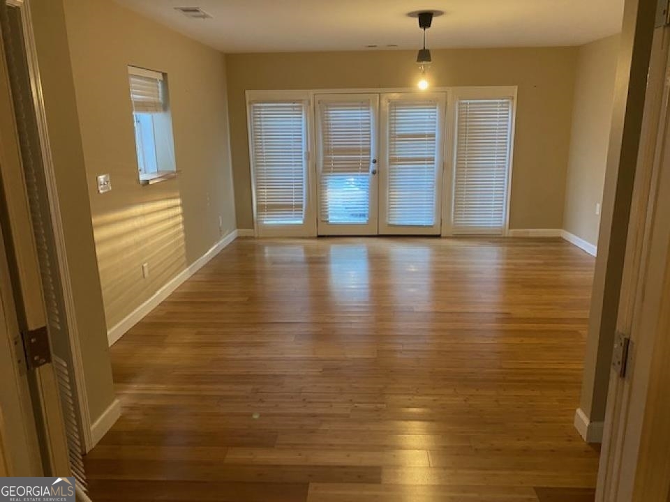 1193 Clifton Road Atlanta, GA 30307 - Photo 17 of 31 a view of an empty room with wooden floor and a window