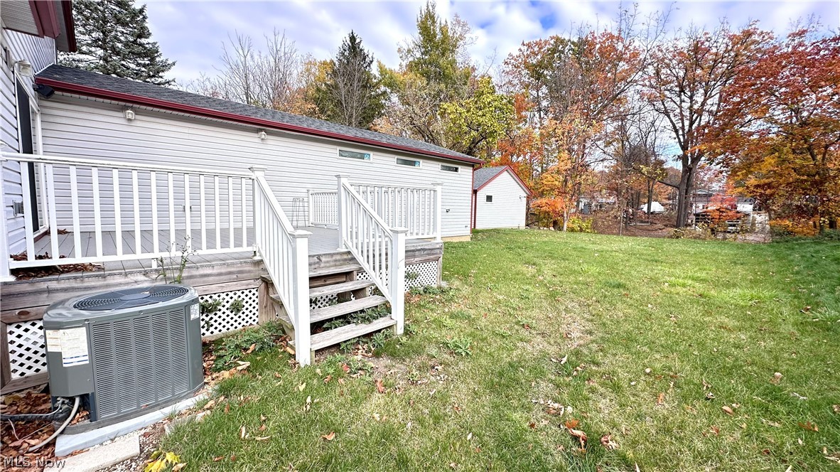 2603 Rockefeller Road Wickliffe, OH 44092 - Photo 32 of 34 Rear exterior featuring a white vinyl-sided structure, a multi-level wood deck with white railings, and a spacious grassy yard