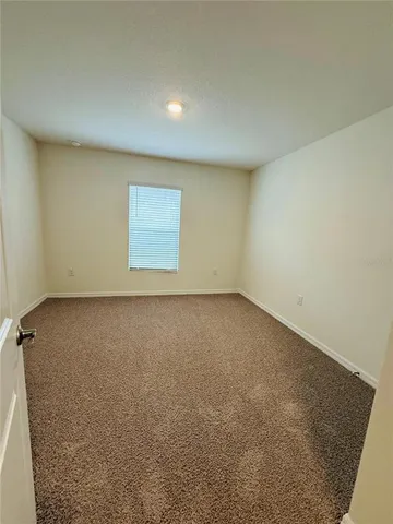 an empty room with a empty space and a window