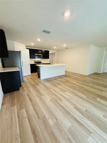 a view of kitchen with sink and microwave