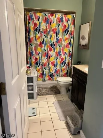 a view of a bathroom with a toilet and a shower curtain