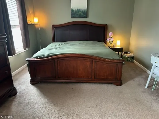 a bed room with a bed and a potted plant