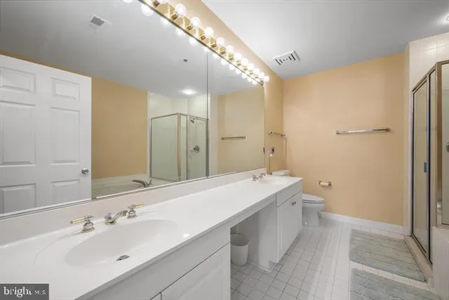 a spacious bathroom with a double vanity sink mirror and double