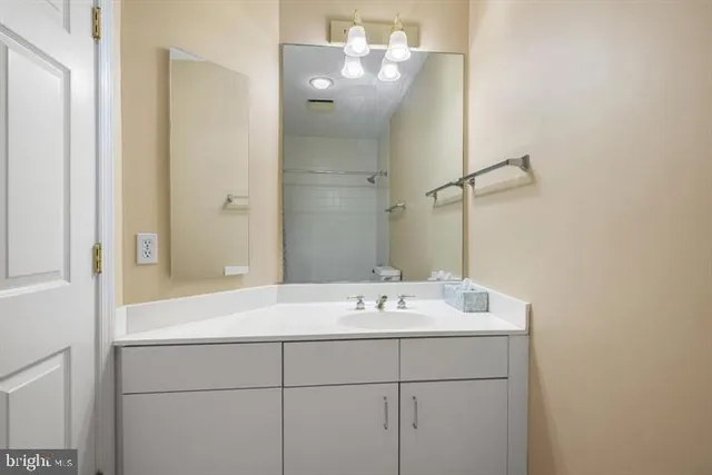 a bathroom with a sink vanity and mirror