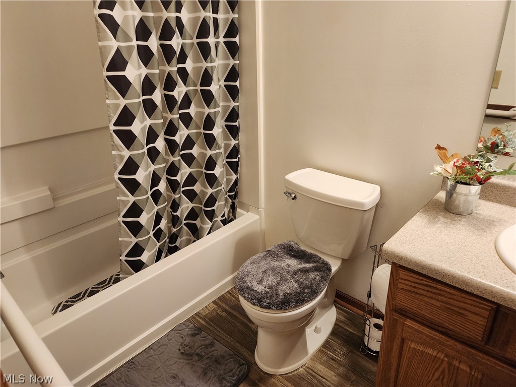 176 Overhill Road Youngstown, OH 44512 - Photo 11 of 20 Master bathroom featuring wood-type flooring, toilet, vanity, and shower / tub combo with curtain