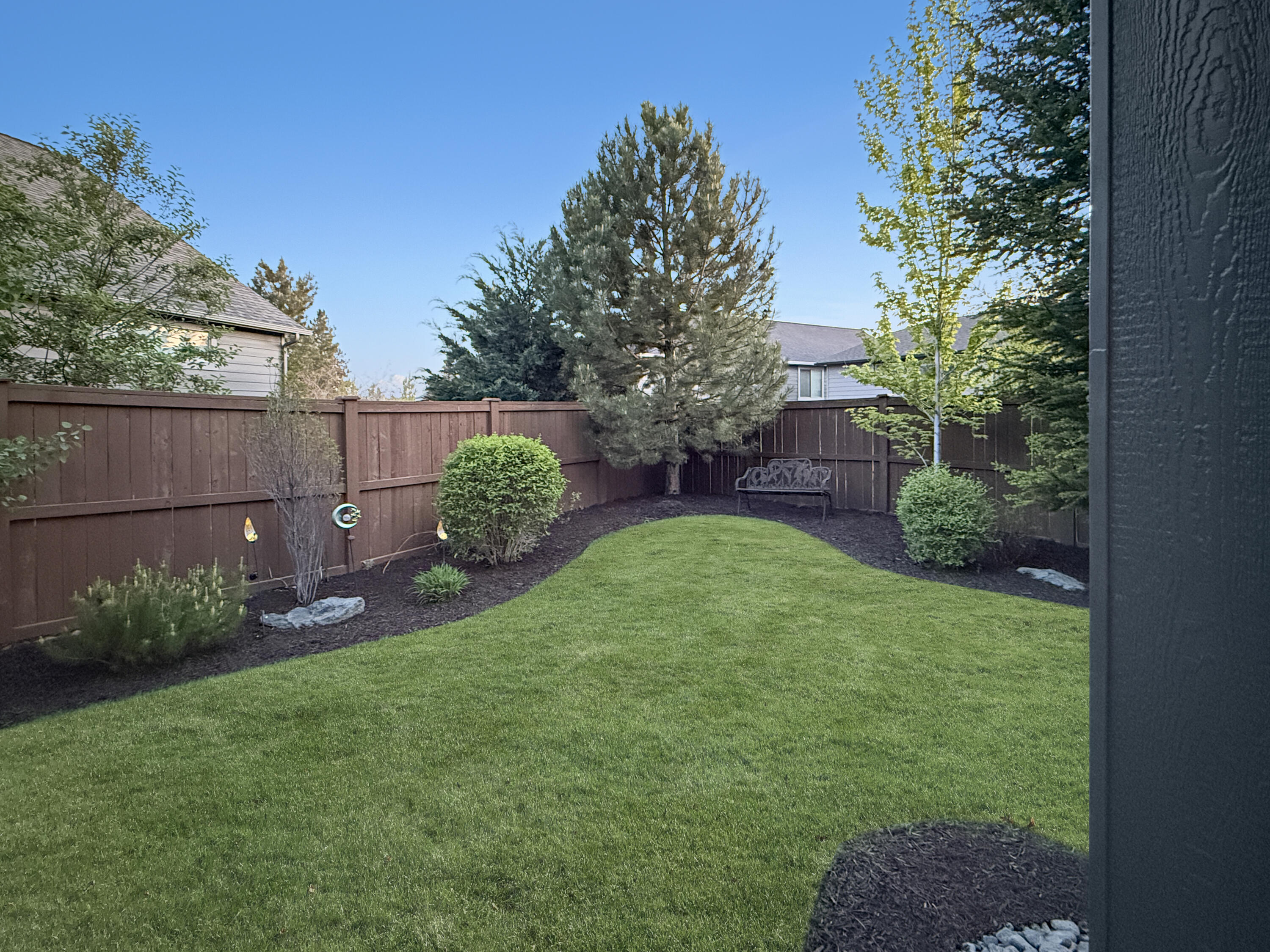 61072 Manhae Loop Bend, OR 97702 - Photo 42 of 63 a view of a backyard with potted plants and large tree
