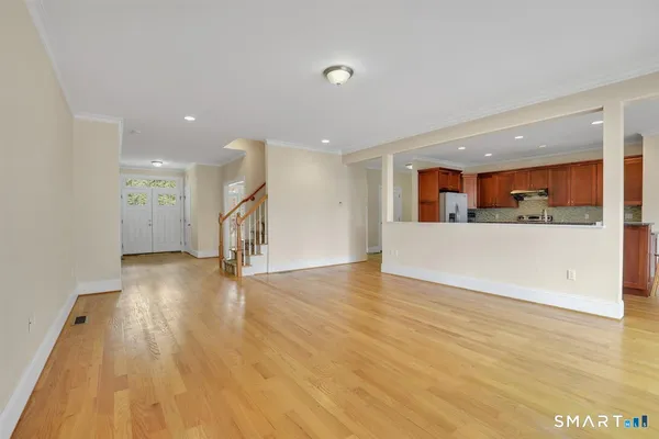 a view of a livingroom with wooden floor and window