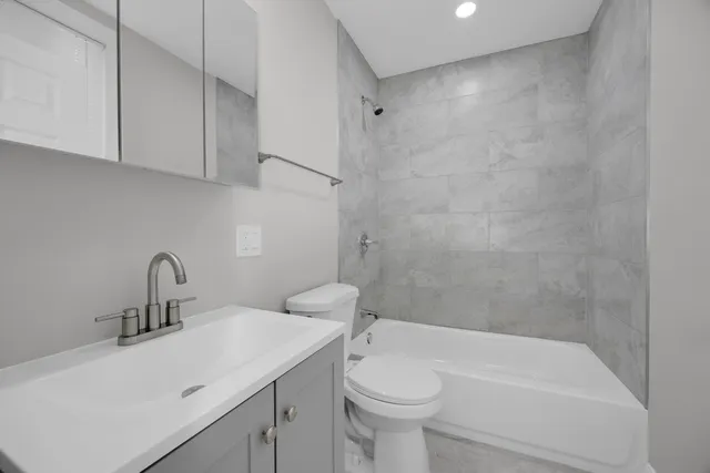 a bathroom with a sink a toilet and bathtub