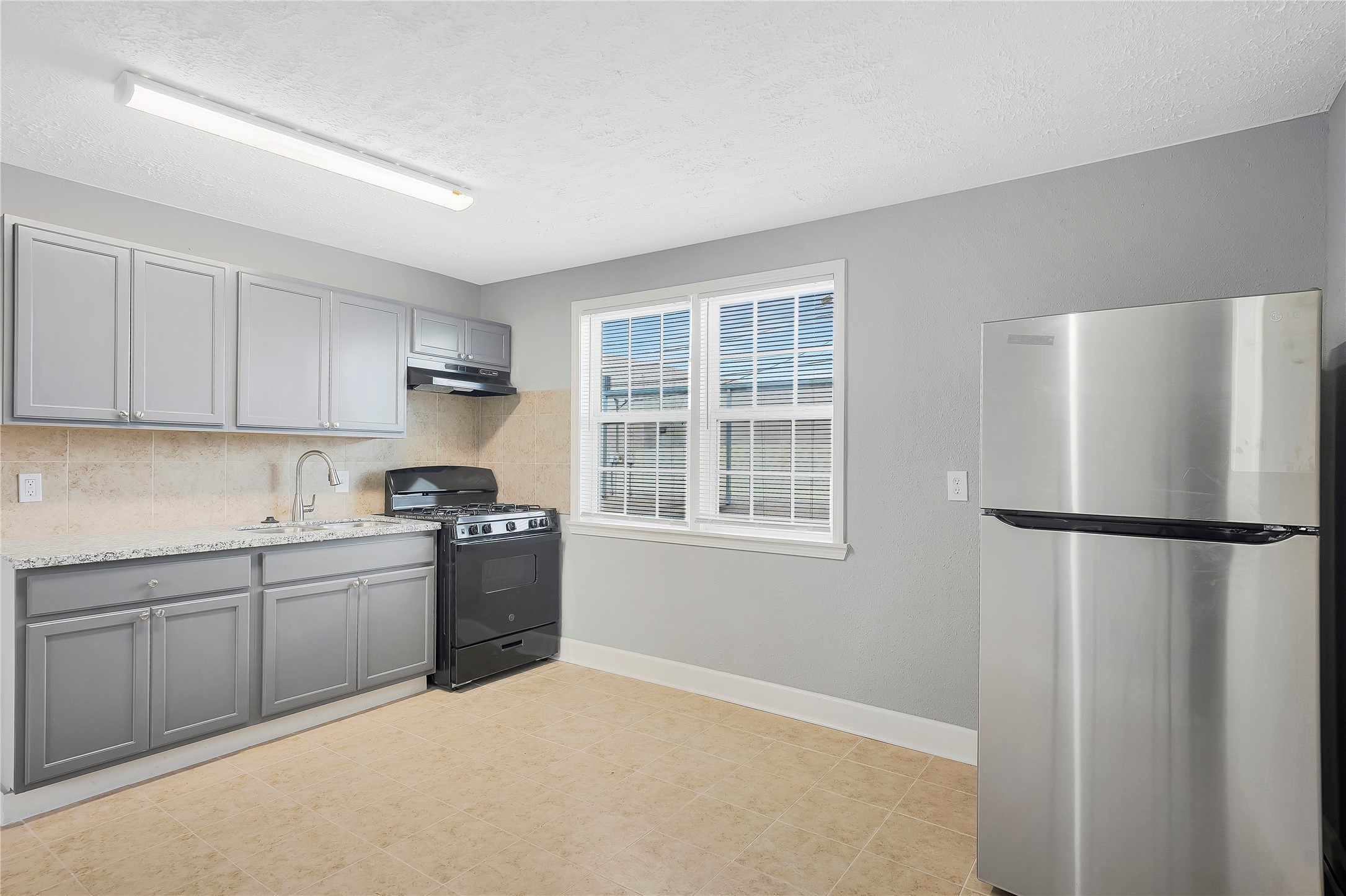 2311 North Louis Street Victoria, TX 77901 - Photo 5 of 20 a kitchen with a refrigerator sink and cabinets