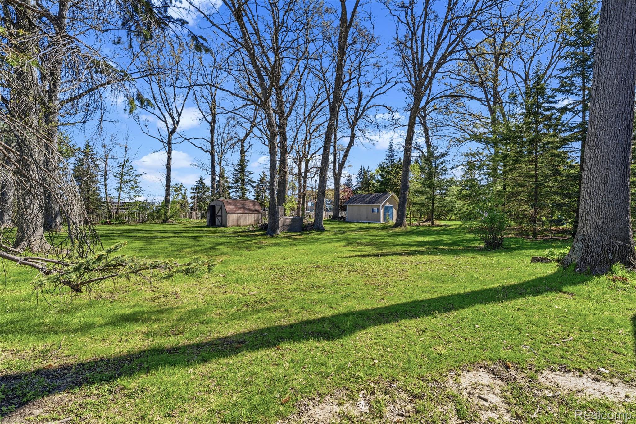 4191 McCandlish Road Grand Blanc, MI 48439 - Photo 44 of 53 View of grassy yard featuring a shed